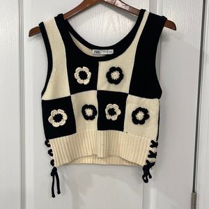 Cropped sweater with side tie detail.